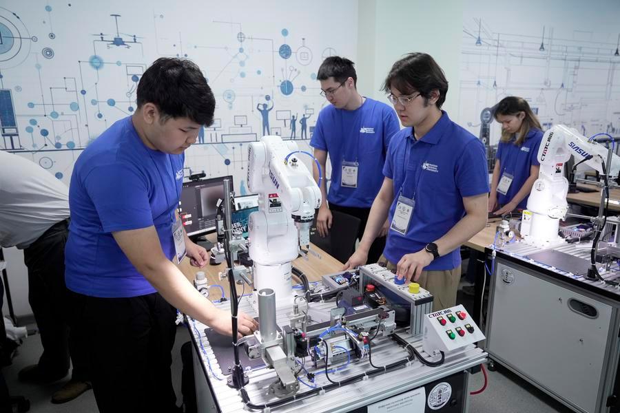 Students operate teaching equipment for the artificial intelligence program at the Luban Workshop at L.N. Gumilyov Eurasian National University in Astana, Kazakhstan, May 22, 2026. (Photo by Kalizhan Ospanov/Xinhua)