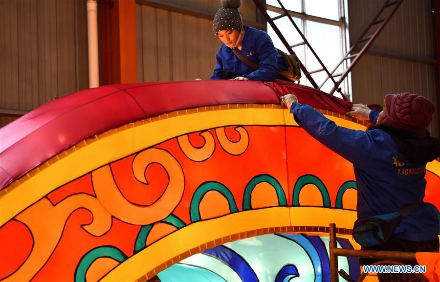 Workers make a large colored lantern at a factory in Xuan
