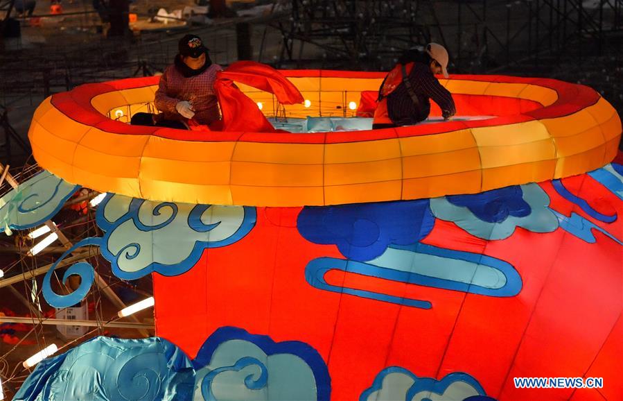 Workers make a large colored lantern at a factory in Xuan