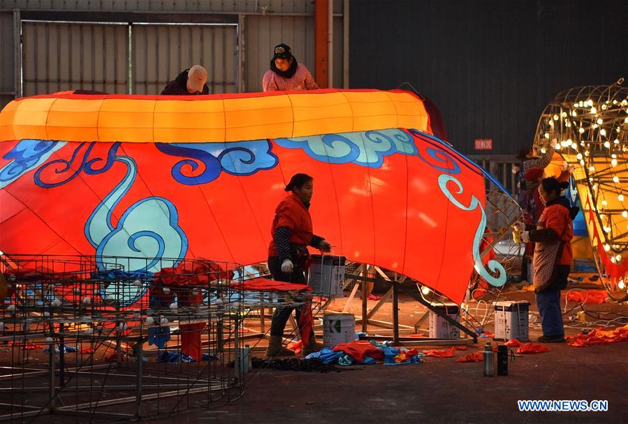 Workers make a large colored lantern at a factory in Xuan